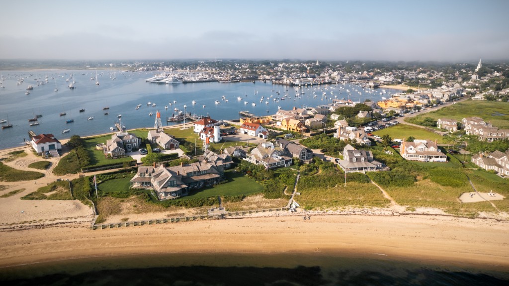 Aerial view of Nantucket harbor, waterfront homes, and beach